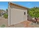 Home exterior featuring a storage shed, mature shade tree, and desert-style landscaping at 2233 E Behrend Dr # 153, Phoenix, AZ 85024