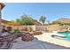 Landscaped backyard with a beautiful fire pit, rock accents, and a cozy seating area at 22521 N 60Th Ave, Glendale, AZ 85310