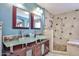 Modern bathroom featuring a glass countertop, dual sinks, and a tiled shower with bench seating at 22521 N 60Th Ave, Glendale, AZ 85310