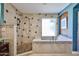 Updated bathroom featuring a luxurious soaking tub and walk-in shower at 22521 N 60Th Ave, Glendale, AZ 85310