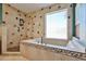 Modern bathroom with large soaking tub and separate shower with tile surround at 22521 N 60Th Ave, Glendale, AZ 85310