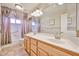 This spacious bathroom includes a double sink vanity with great lighting, as well as a tub/shower combo at 22521 N 60Th Ave, Glendale, AZ 85310