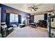 Inviting bedroom features a cozy bed, sleek ceiling fan, dark walls, and ample storage for comfortable living at 22521 N 60Th Ave, Glendale, AZ 85310