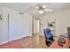 Bright bedroom with wood floors, ceiling fan, large closet, and a work space at 22521 N 60Th Ave, Glendale, AZ 85310