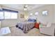 This carpeted bedroom has great natural light, unique windows and a ceiling fan at 22521 N 60Th Ave, Glendale, AZ 85310