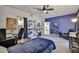 This carpeted bedroom boasts great natural light, ceiling fan, a blue accent wall and is a perfect space for rest and relaxation at 22521 N 60Th Ave, Glendale, AZ 85310