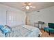 This carpeted bedroom has great natural light, a ceiling fan and closet space at 22521 N 60Th Ave, Glendale, AZ 85310