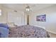 This carpeted bedroom has great natural light, closet space and a ceiling fan at 22521 N 60Th Ave, Glendale, AZ 85310