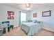 This cheerful carpeted bedroom has great natural light, a ceiling fan and fun decor at 22521 N 60Th Ave, Glendale, AZ 85310