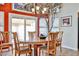 Bright dining room with a chandelier, adjacent to a living space, and filled with natural light at 22521 N 60Th Ave, Glendale, AZ 85310