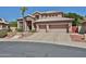 Charming two-story home featuring a tile roof, three-car garage, and well-manicured front yard at 22521 N 60Th Ave, Glendale, AZ 85310