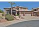 Charming two-story home featuring a tile roof, mature trees, and a three-car garage at 22521 N 60Th Ave, Glendale, AZ 85310