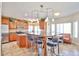 Bright kitchen featuring an island with seating, wood cabinetry, stainless steel appliances and lots of counterspace at 22521 N 60Th Ave, Glendale, AZ 85310