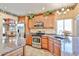 Modern kitchen with stainless steel appliances, granite countertops, and wooden cabinets provides a functional and stylish cooking space at 22521 N 60Th Ave, Glendale, AZ 85310