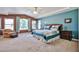 Spacious main bedroom with large window, sitting area, ceiling fan and ensuite bath at 22521 N 60Th Ave, Glendale, AZ 85310