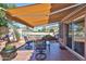 Charming patio area with shade awning, comfortable seating, and pool views at 22521 N 60Th Ave, Glendale, AZ 85310