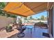 Inviting patio space with comfortable seating and retractable awning overlooking the pool at 22521 N 60Th Ave, Glendale, AZ 85310