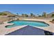 Stunning backyard featuring a sparkling pool, waterfall feature, and desert landscape views at 22521 N 60Th Ave, Glendale, AZ 85310