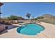 Resort-style backyard oasis with a sparkling pool, rock waterfall, and desert views at 22521 N 60Th Ave, Glendale, AZ 85310