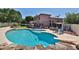 Inviting backyard featuring a large pool, diving board, and patio area perfect for outdoor entertaining at 22521 N 60Th Ave, Glendale, AZ 85310