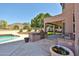 Backyard with a built-in grill, covered patio, sparkling pool and desert mountain views at 22521 N 60Th Ave, Glendale, AZ 85310