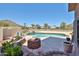 Beautiful backyard featuring a swimming pool, waterfall feature, and desert landscape at 22521 N 60Th Ave, Glendale, AZ 85310