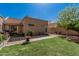 Charming backyard featuring lush green grass, brick pavers and a covered patio, perfect for outdoor living and entertaining at 2348 W Comstock Dr, Chandler, AZ 85224