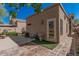 Enclosed backyard featuring brick pavers, synthetic grass, a charming fountain and convenient access to the home at 2348 W Comstock Dr, Chandler, AZ 85224