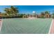 Well-maintained fenced basketball court with lush landscaping, perfect for sports and recreation at 2348 W Comstock Dr, Chandler, AZ 85224