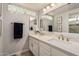 Updated bathroom with double sink vanity, tile backsplash, and modern fixtures at 2348 W Comstock Dr, Chandler, AZ 85224