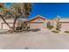 View of single-story home featuring a tile roof, two-car garage, and low-maintenance landscaping at 2348 W Comstock Dr, Chandler, AZ 85224