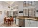 White cabinets, granite countertops, stainless steel appliances, and a breakfast nook at 2348 W Comstock Dr, Chandler, AZ 85224