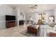 Cozy living room with fireplace, tv, and sliding door to the backyard at 2348 W Comstock Dr, Chandler, AZ 85224