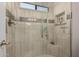 Updated shower with glass door, seat, and tile surround at 2348 W Comstock Dr, Chandler, AZ 85224