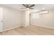 Comfortable bedroom with closet, cooling unit, fan, and light wood flooring at 2356 W Catalina Ave, Mesa, AZ 85202
