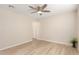 This neutral bedroom offers a ceiling fan, light wood flooring, and neutral paint at 2356 W Catalina Ave, Mesa, AZ 85202