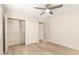Comfortable bedroom with open closet, fan, and light wood flooring at 2356 W Catalina Ave, Mesa, AZ 85202