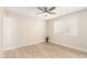 Bright bedroom features sleek ceiling fan, light wood floors and abundant natural light from large window at 2356 W Catalina Ave, Mesa, AZ 85202