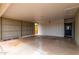 Carport featuring corrugated steel, concrete pad, and access to backyard at 2356 W Catalina Ave, Mesa, AZ 85202