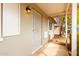 Covered front porch with security screen door and vintage exterior light fixture at 2356 W Catalina Ave, Mesa, AZ 85202