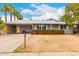 Charming single-story home featuring desert landscaping, a covered parking area, and a welcoming front porch at 2356 W Catalina Ave, Mesa, AZ 85202