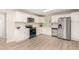 The bright kitchen boasts white cabinets, stainless steel appliances, and a modern design at 2356 W Catalina Ave, Mesa, AZ 85202