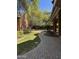 Backyard showcasing a patio and a gazebo surrounded by greenery and a winding brick path at 2904 W Belmont Ave, Phoenix, AZ 85051