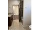 Bathroom with dark wood cabinet vanity, tile floors, and separate tub and shower at 2904 W Belmont Ave, Phoenix, AZ 85051