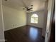 Bright bedroom with wood-look tile floor, ceiling fan, and a large window, offering lots of natural light at 2904 W Belmont Ave, Phoenix, AZ 85051