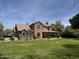 Sprawling two-story brick home on a large lot with mature trees and well-manicured lawn at 2904 W Belmont Ave, Phoenix, AZ 85051