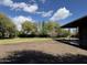 Expansive front yard with lush green lawn, mature trees, and a circular driveway offers a serene and private setting at 2904 W Belmont Ave, Phoenix, AZ 85051