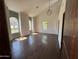 Spacious living room featuring wood-look tile floors, high ceilings, and abundant natural light from arched windows at 2904 W Belmont Ave, Phoenix, AZ 85051