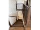 A home staircase featuring dark wooden steps and metal railings at 2904 W Belmont Ave, Phoenix, AZ 85051