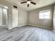 Bedroom showcasing wood-look vinyl flooring, ceiling fan, and bright window at 2945 N 19Th Ave # 78, Phoenix, AZ 85015